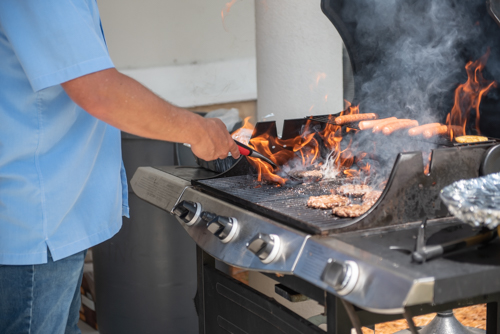 Flames on a grill while cooking lunch for Customer Appreciation Day at Mainstreet Community Bank